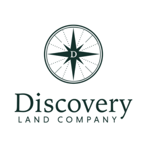 Discovery Land Company logo with a compass rose emblem